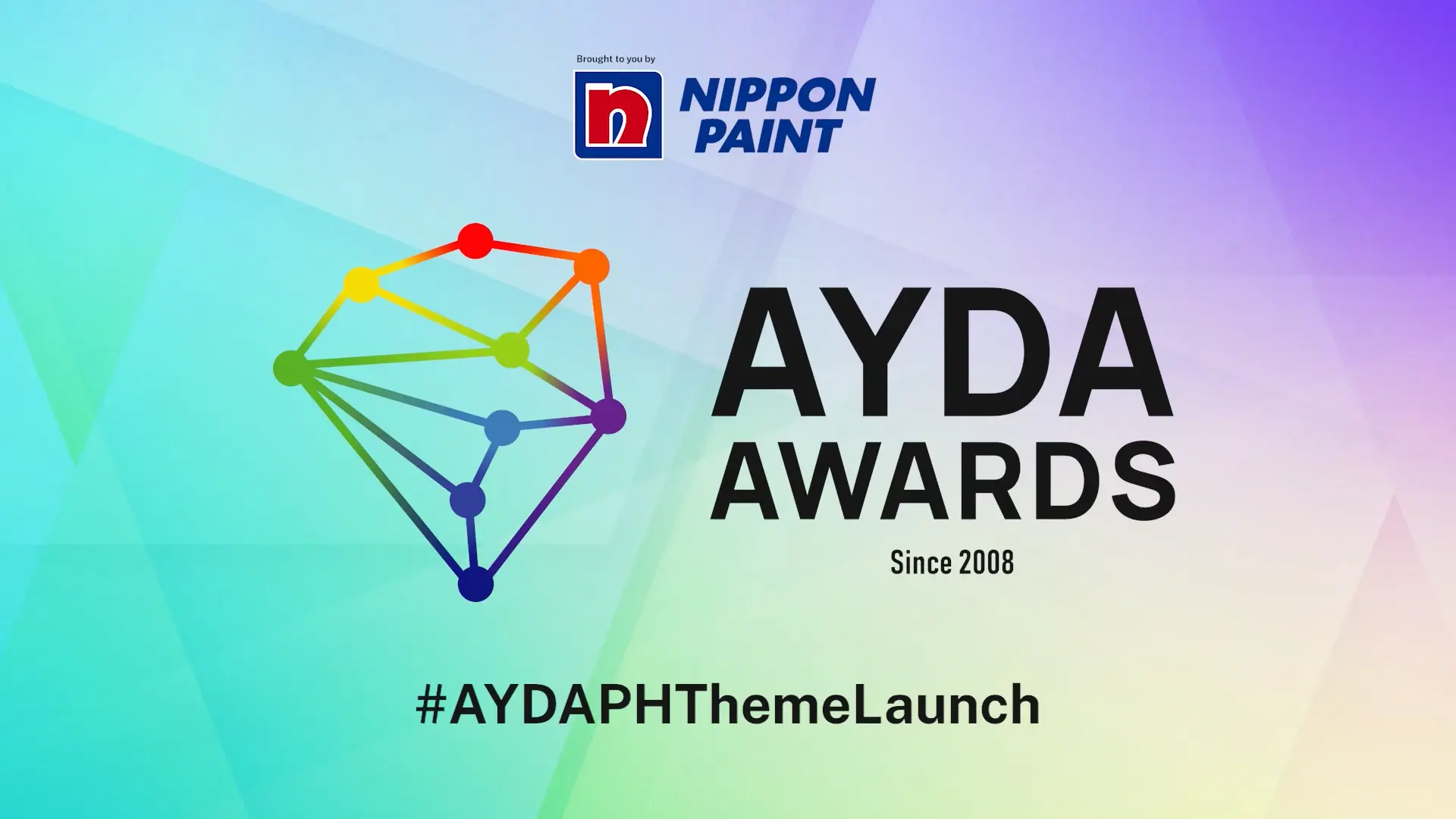 The official event screen for the AYDA Awards by Nippon Paint. It features the AYDA Awards logo, a colorful geometric shape, and the hashtag #AYDAPHThemeLaunch on a vibrant gradient background.